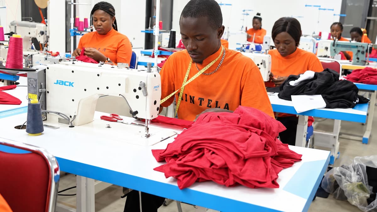 Kintela production team working at sewing machines inside the Abuja garment factory